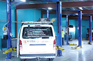 Auto workshop fitted with 2 post hoists in each service bay