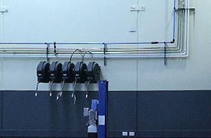 Lubrication reels connected to high pressure lines inside workshop facility