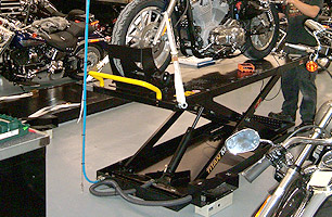 Motorcycle scissor lifts installed in multi service bay workshop