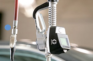 Close up of dispenser shoing connection to high pressure lines, trigger and meter reading screen