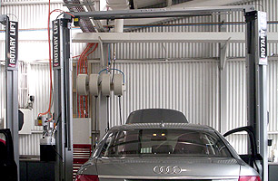 Automotive workshop fit-out with 2 post hoists and lubrication reels at end of each service bay