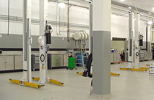 Automotive workshop fitout with 2 post hoists, lubrication reels and fume extraction system