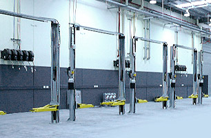 Auto workshop fitout with 2 post hoists and lubrication reels fitted between pairs of service bays